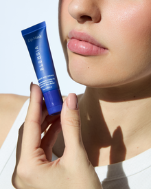 ELEUSIA Barrier Restoring Lip Mask in Cucumber product in hand, moisturizing treatment product.