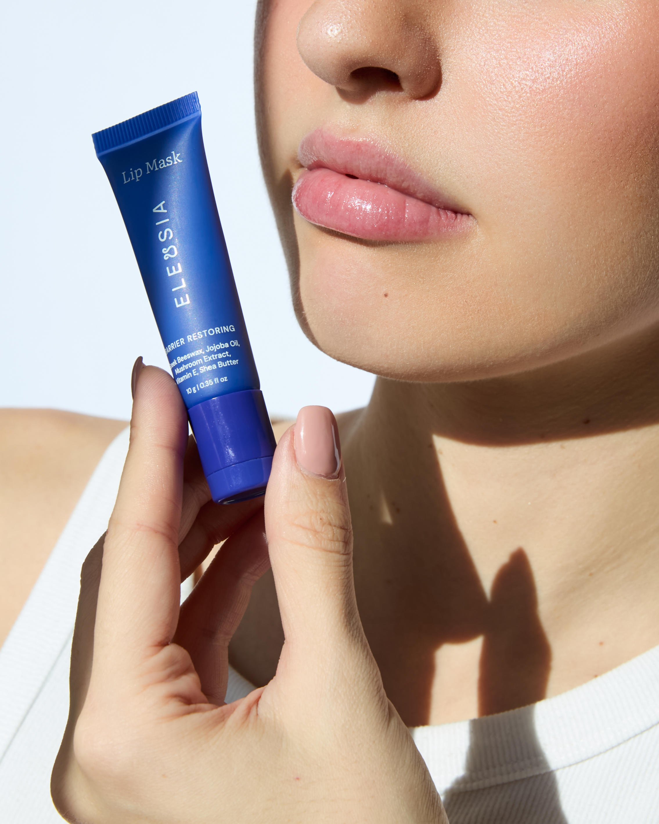 ELEUSIA Barrier Restoring Lip Mask in Cucumber product in hand, moisturizing treatment product.