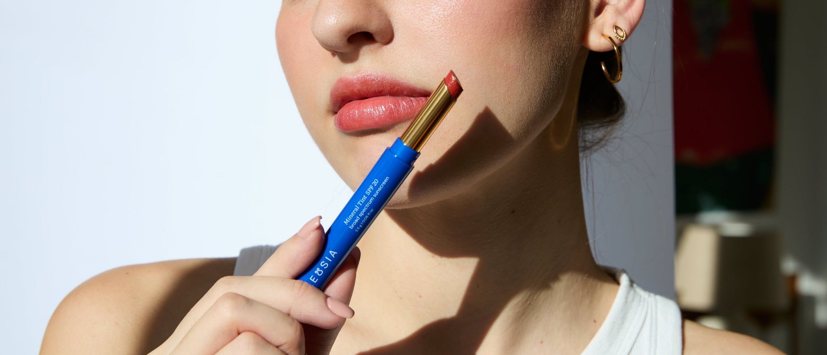 ELEUSIA Mineral Lip Tint SPF 20 in Antioxidant Fig applied on lips, showing tinted finish and product detail.