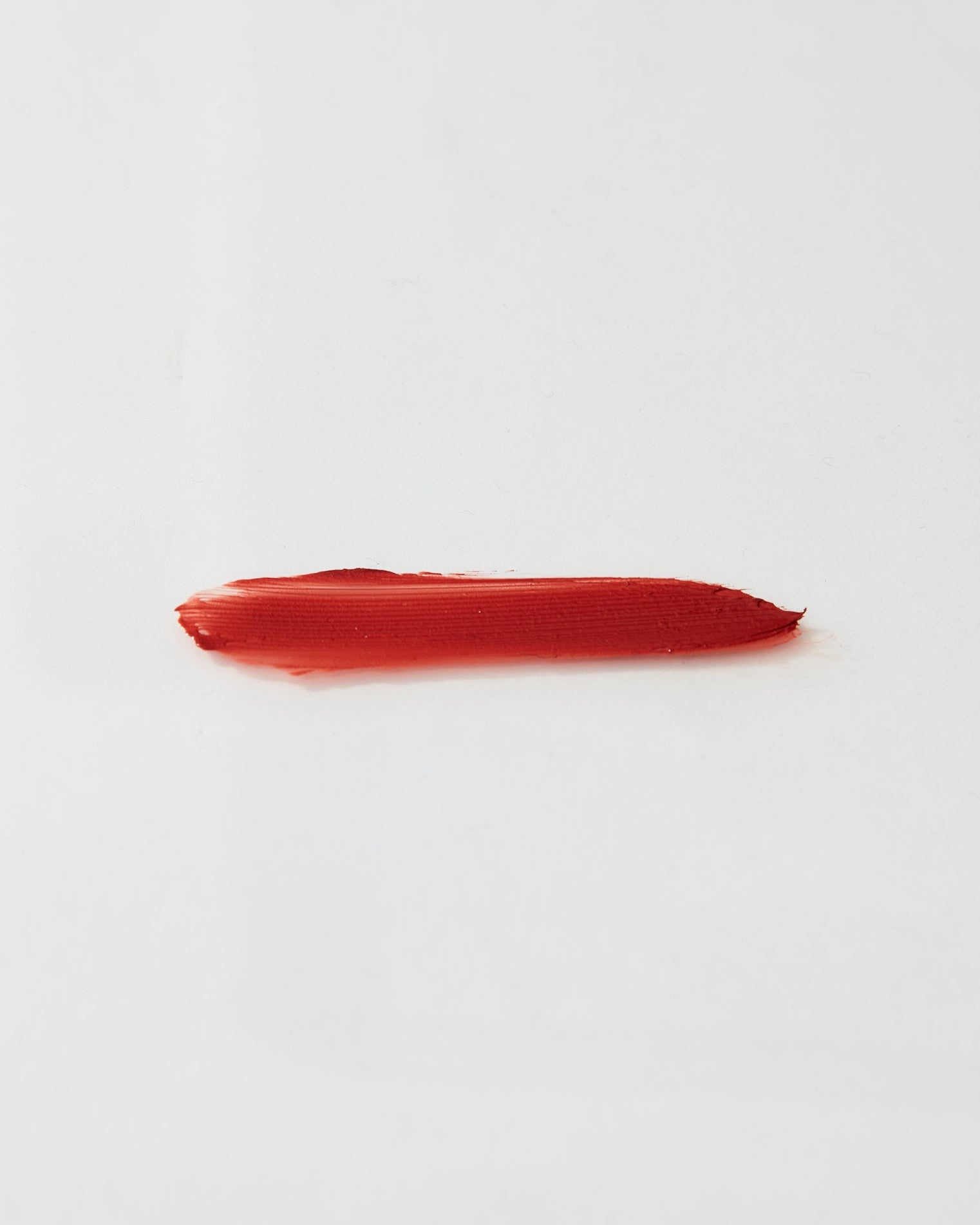 Red lipstick swatch on a white background