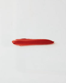 Red lipstick swatch on a white background