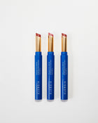 Three blue Eleusia lip products with visible brand name on a white background